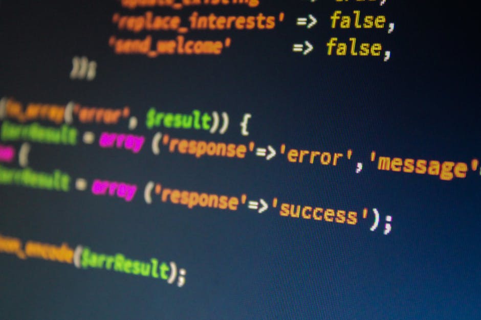 Close-up image of a computer screen displaying a code editor with syntax-highlighted JavaScript code. The code includes colored keywords such as 'true' in orange, 'result' in green, and 'error' in mag